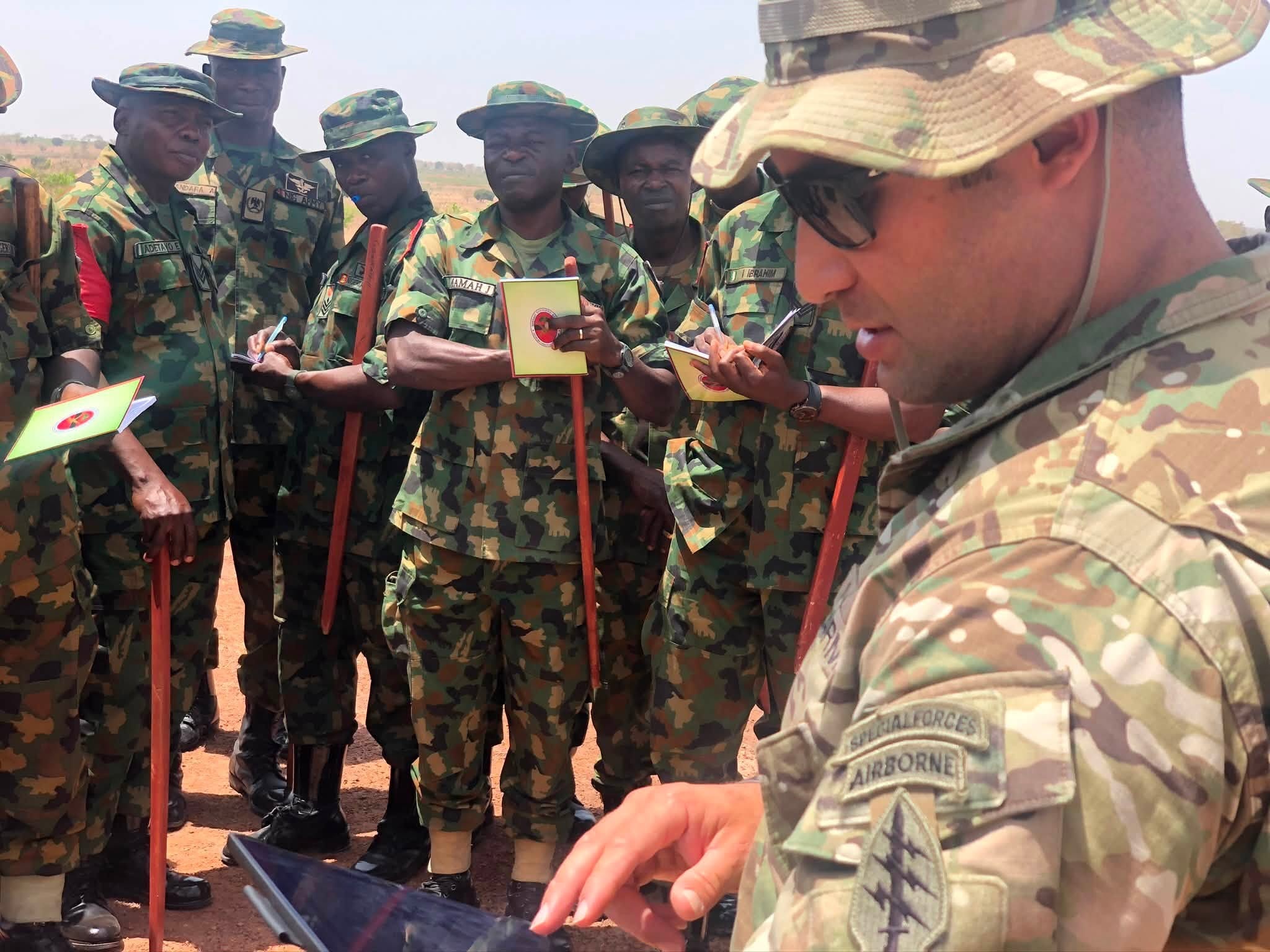 Sam briefing Nigerian soldiers in the field